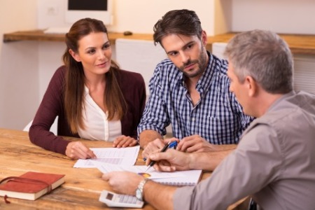 Image of a group of people looking at a document