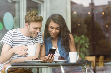 Image of a couple looking at cell phone