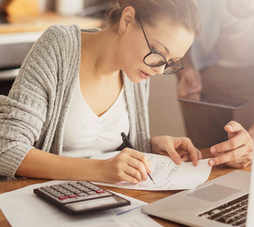 Image of a lady working on paperwork.