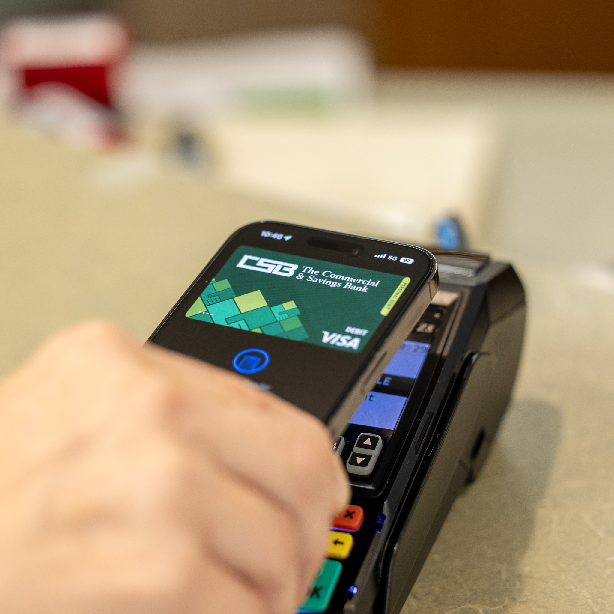 Customer taps CSB debit card in Apple Wallet to card reader.