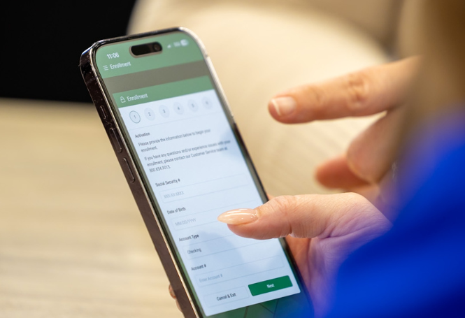 Person enrolling in CSB mobile banking on smartphone
