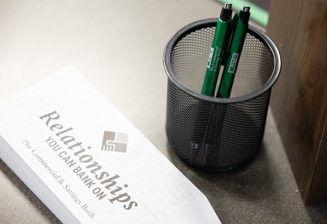 Drive-thru money envelope and CSB pens on bank counter.