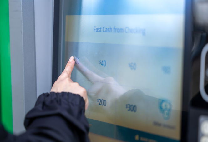 Customer selecting fast cash withdrawal on ATM touchscreen