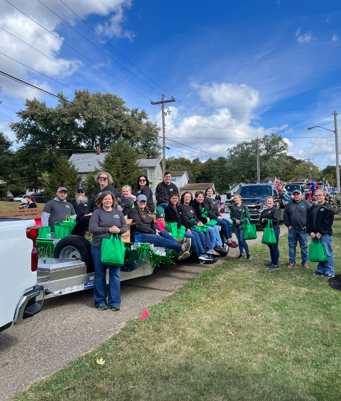 CSB team members participating in the Holmes County parade on a decorated float.