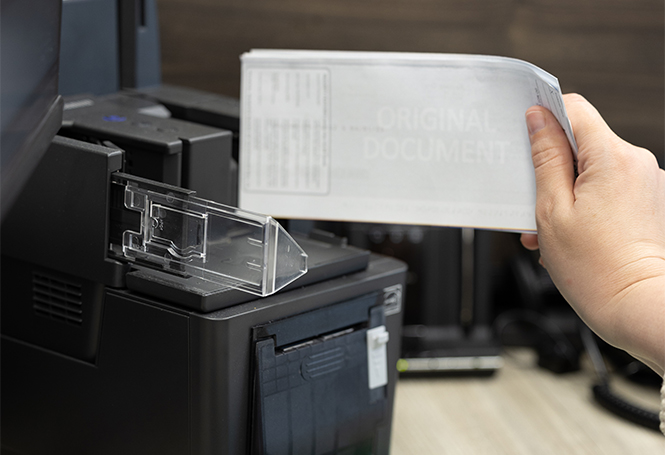 Teller scanning checks.