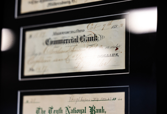 Historic handwritten CSB check displayed in black frame