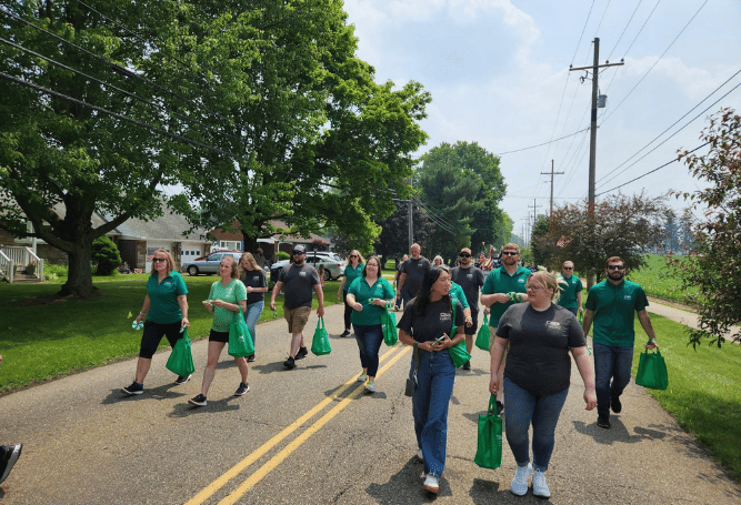 Commercial & Savings Bank employees walk together during a community parade.