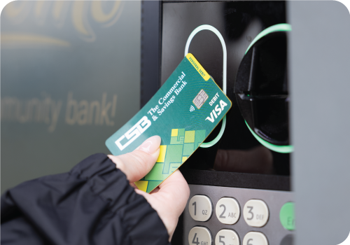 Customer tapping a CSB debit card at an ATM.