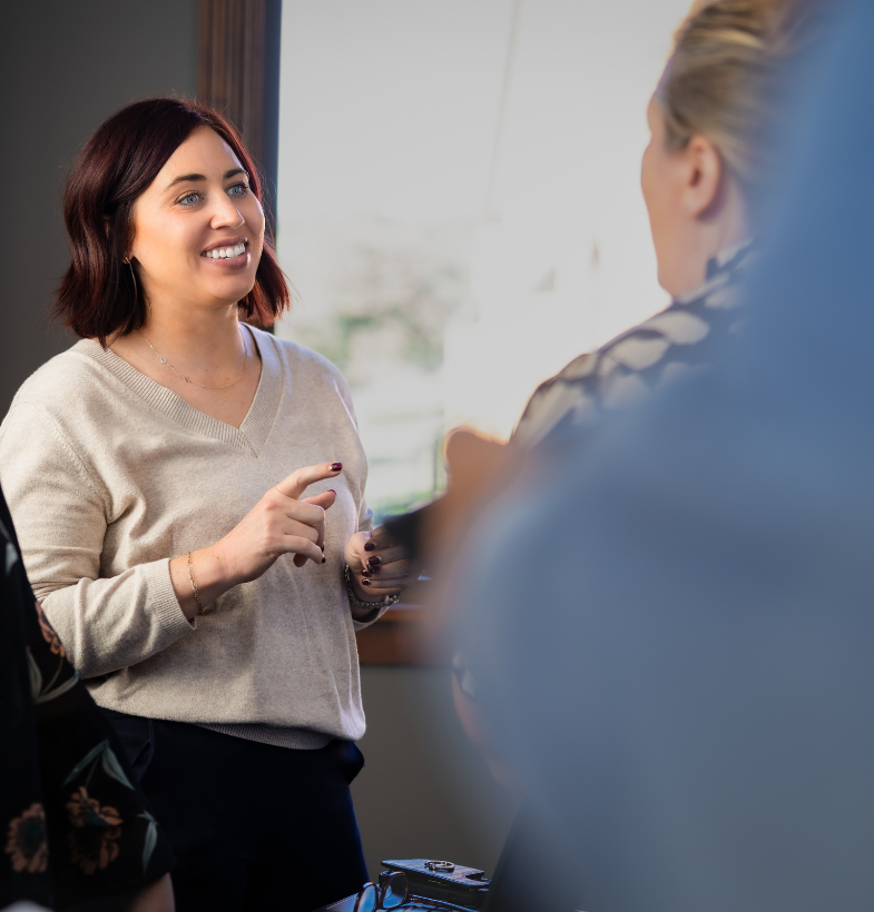 Smiling woman talking to another woman