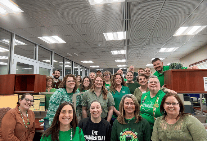 Commercial & Savings Bank employees gather for a team photo inside our Customer Service Center office.